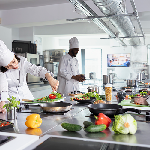 Cozinha industrial com equipamentos de grande porte para fritura em escala